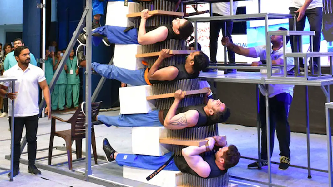 Martial arts pros form 8-layer bed of nails sandwich in record-breaking stunt
