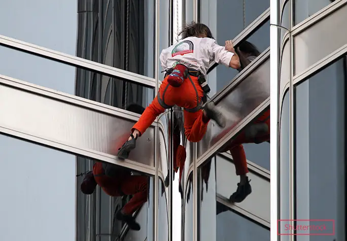 Alain Robert climbing windows