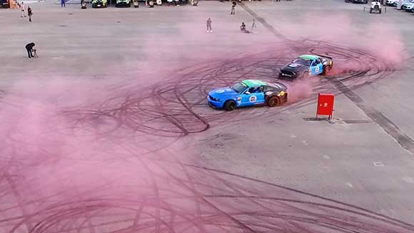 Racing drivers create giant tyre mark image of breast cancer awareness ribbon in Saudi Arabia