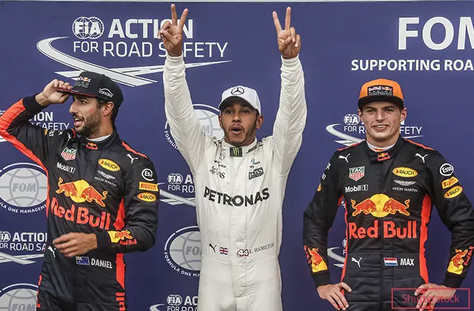 Lewis Hamilton (centre) celebrates qualifying in pole position ahead of Max Verstappen (right) and Daniel Ricciardo (left) at the 2017 Italian Grand Prix