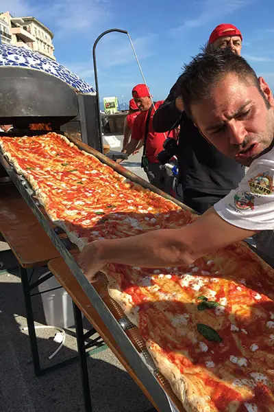 Italian Chefs Create Mile Long Neapolitan To Break Longest Pizza Record Guinness World Records break longest pizza record
