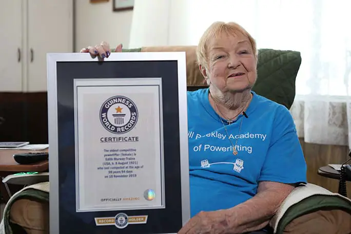Oldest-competitve-powerlifter-edith-murway-traina-with-her-Guinness-World-Records-certificate
