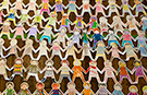 Watch time lapse video of the making of the world's longest paper doll chain