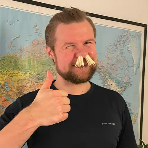 Peter with matches in his nose with thumbs up