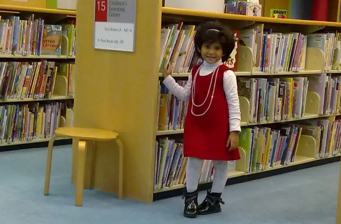 Ritaj Hussain as a young girl in a library