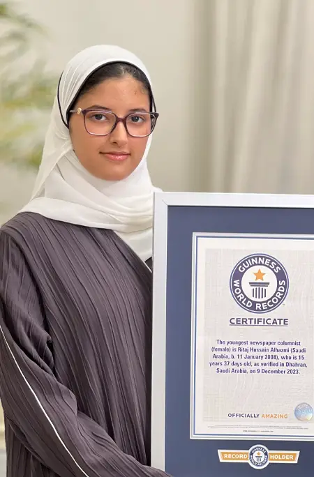 Ritaj Hussain posing while holding her record certificate