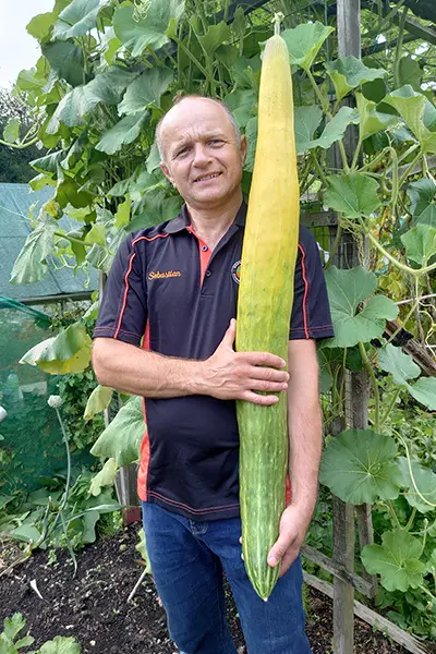 Sebastian Suski holding the worlds longest cucumber