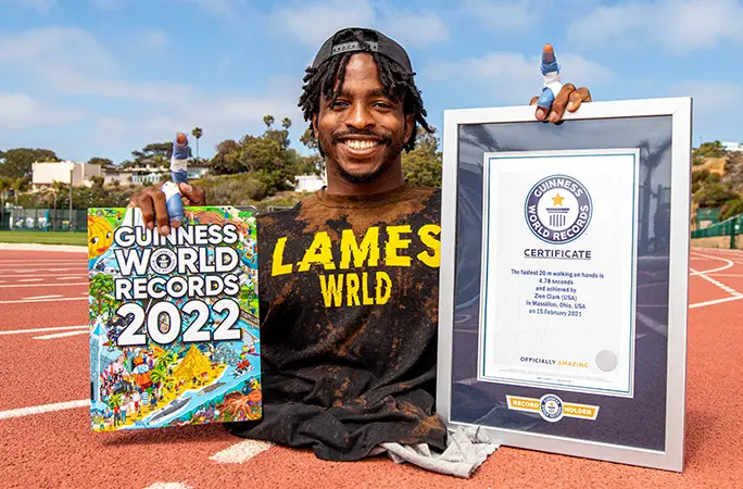 Zion with his first certificate and the Guinness World Records 2022 edition