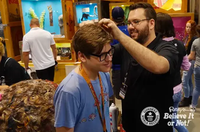 boy donating hair to hoss the hairball