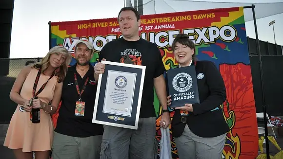 New fiery record achieved for eating the most Carolina reaper chilis in a  minute | Guinness World Records