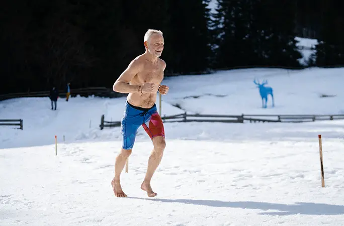 Topless man braves cold to run fastest barefoot ice half marathon in snowy mountains