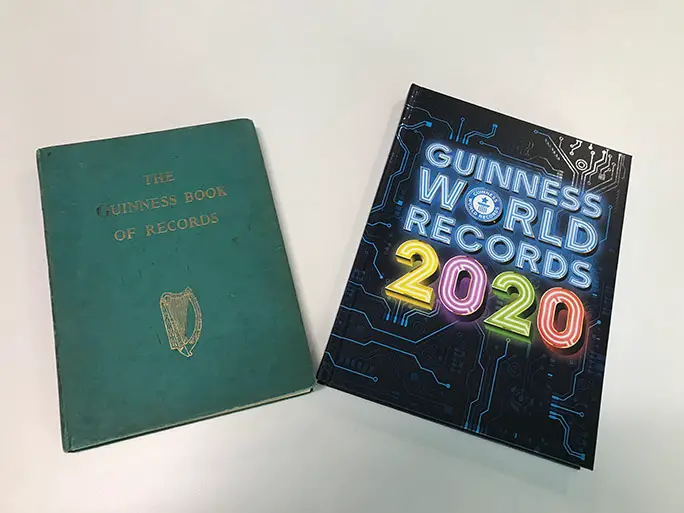 The first Guinness World Records book from 1955 alongside the current editi...