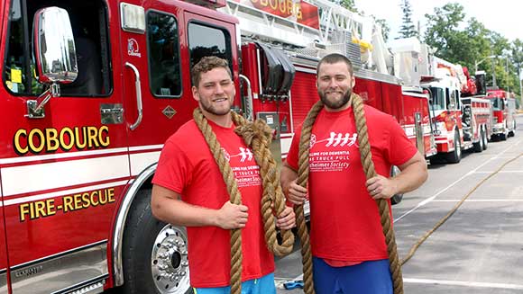Watch Canadian brothers haul three fire engines in bid to break father's record 