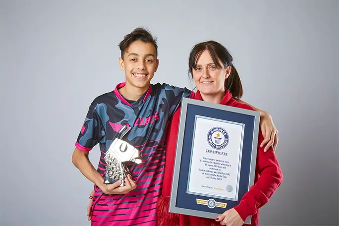Jaden with his Fortnite World Cup trophy and proud mum, Lisa