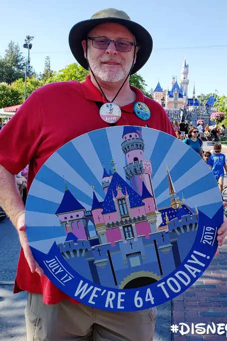 jeff-smiling-as-he-holds-up-disney-sign.jpg