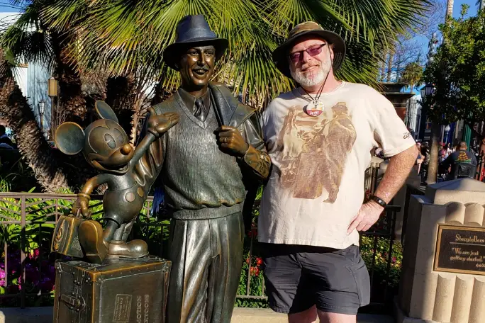 jeff-smiling-as-he-poses-with-mickey-and-walt-disney-statue.jpg