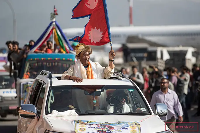 Flying the Nepali flag during a procession in the country's capital, after his 24th ascent of Everest