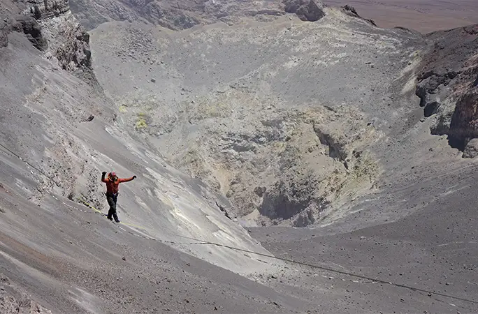 Matías walking a highline over Lascar volcano