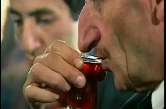 mehmet ozyurek taking a sip of his drink