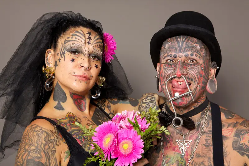 Most body modification married couple with pink flowers latam
