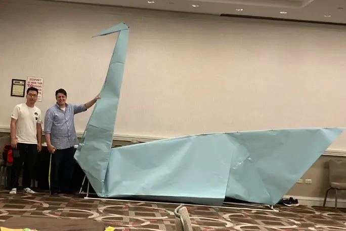 paul-frasco-and-ryan-dong-standing-by-largest-origami-swan.jpg