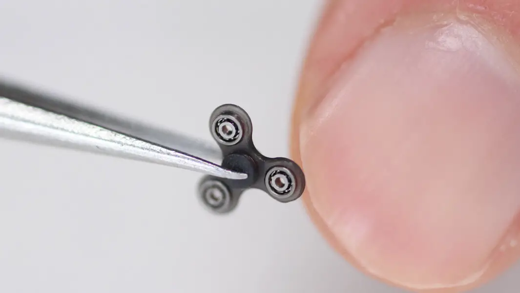 Video: World's smallest fidget spinner is so tiny it will easily fit on  your fingertip