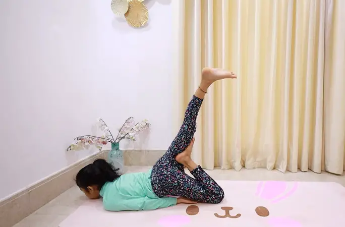 youngest yoga instructor female practicing yoga at home