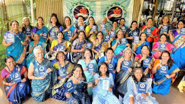  Participants wearing sahris showcasing their certificates of participation