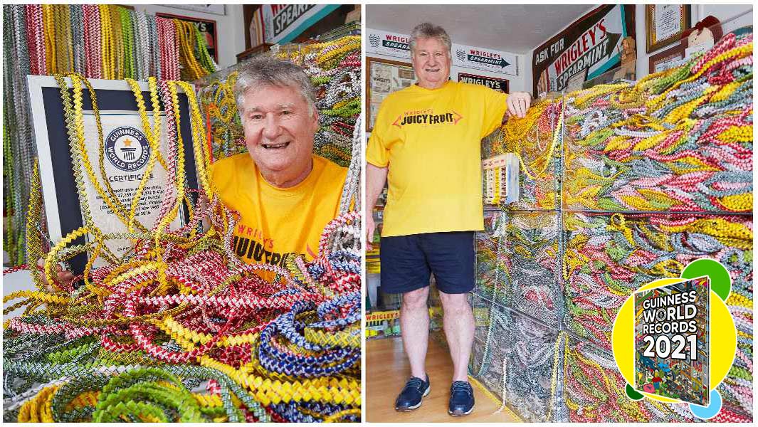 longest gum wrapper chain draped over certificate with record holder standing next to it