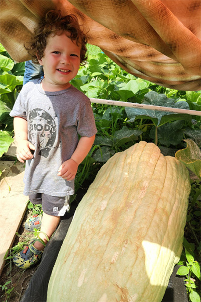 Derek's son standing next to the squash