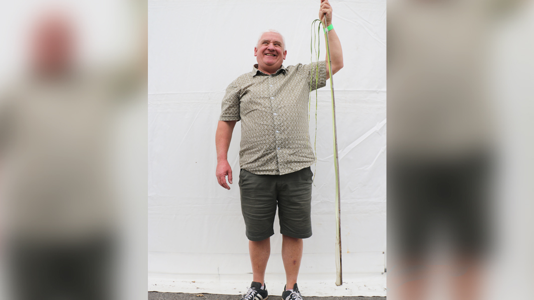 Hulme showing giant leek and smiling blurred background