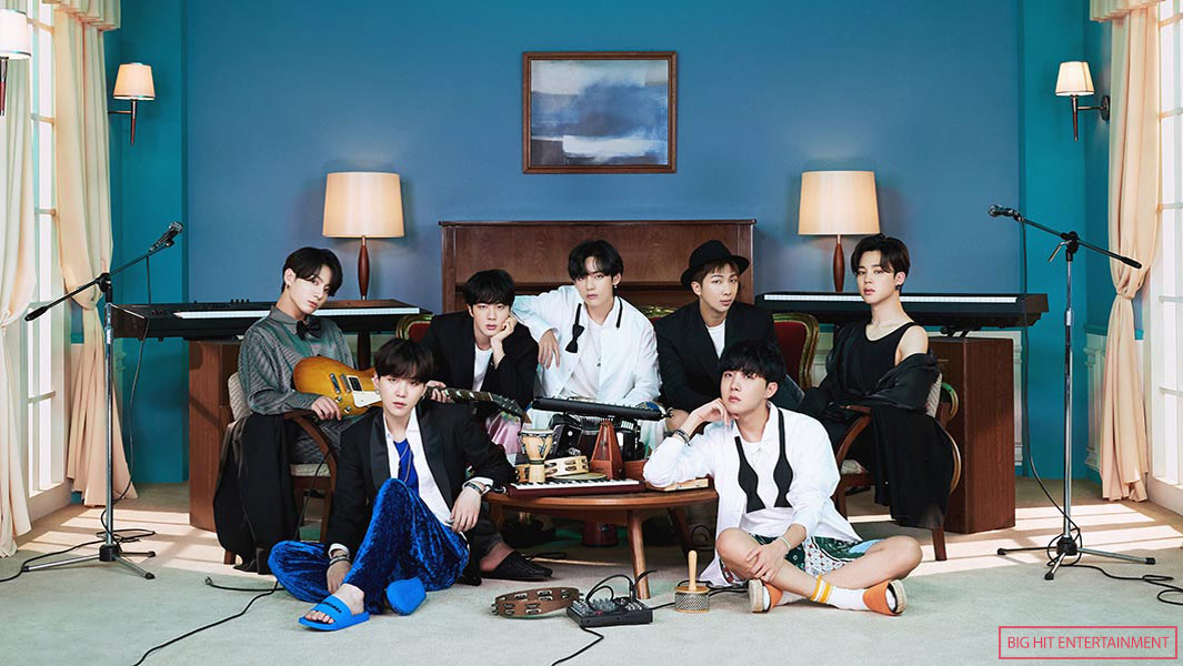 BTS sitting with blue background header