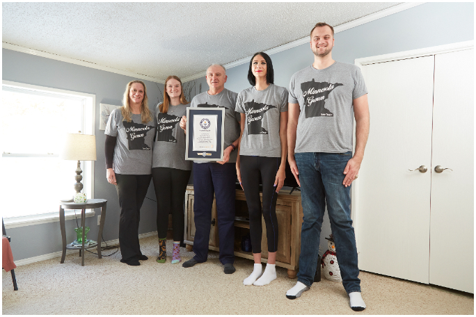 Trapp family posing with their certificate