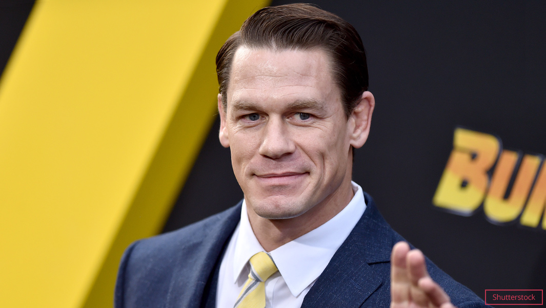 John Cena in suit waving at camera