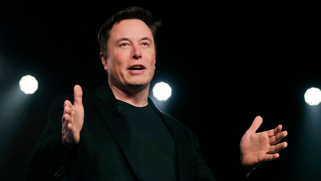 Elon Musk with hands outstretched
