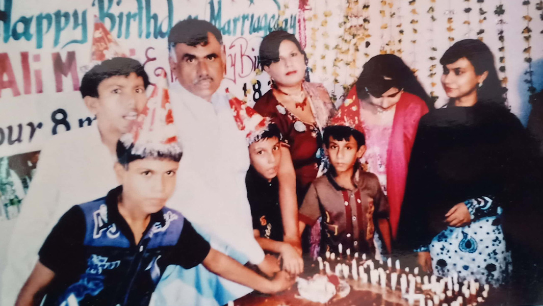 Mangi family cutting birthday cake