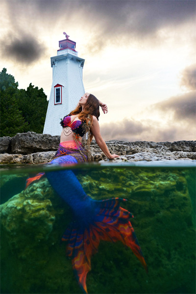 model as a meraid in front of lighthouse