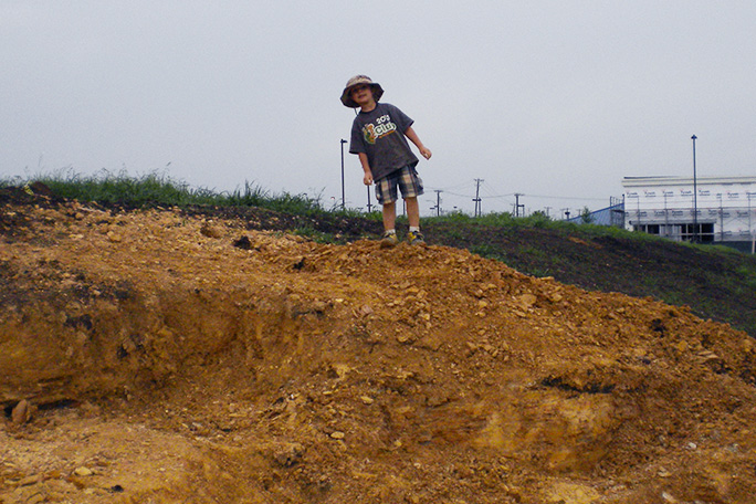 wylie-brys-standing-where-he-found-dinosaur-bones.jpg