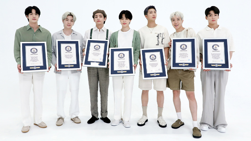 BTS lined up holding Guinness World Records certificates