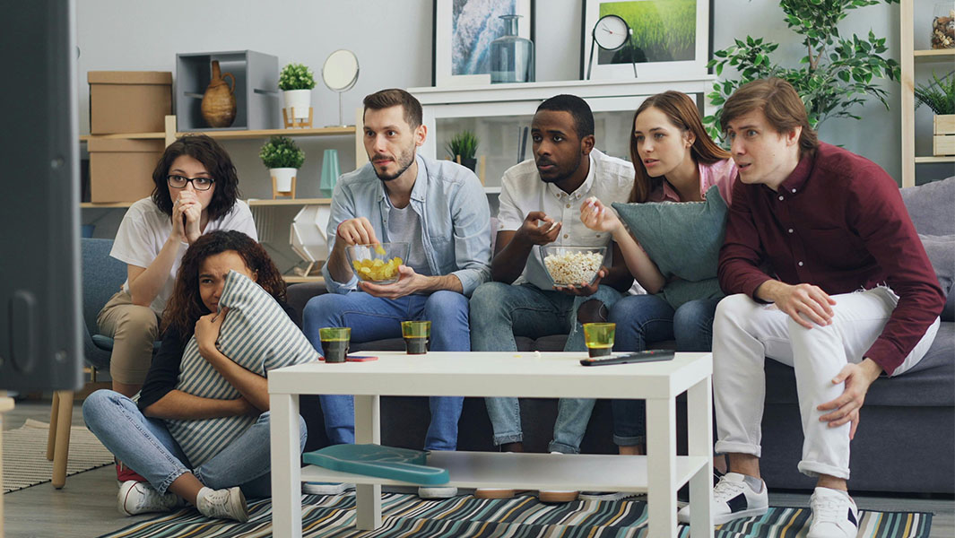 A group of people watching a scary movie