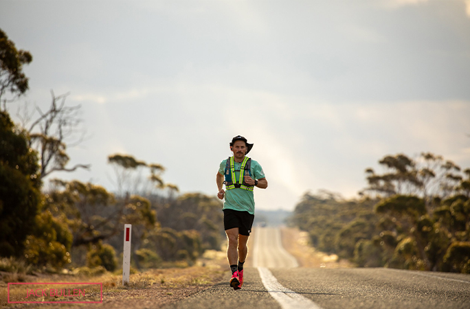 Chris running down an empty road