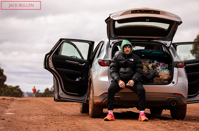 Chris sitting in the boot of a support vehicle