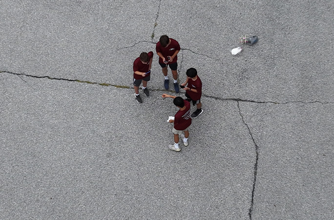 Group gathered on the ground waiting for the drop