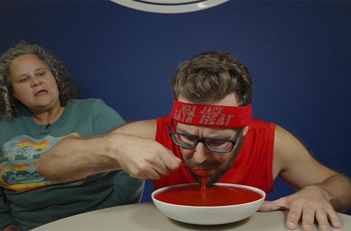 Mike eating hot sauce with a spoon