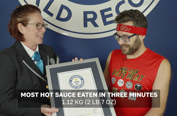Mike getting his hot sauce certificate from Juliet Dawson