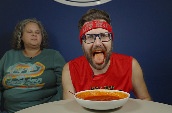 Mike holding his mouth open after eating hot sauce