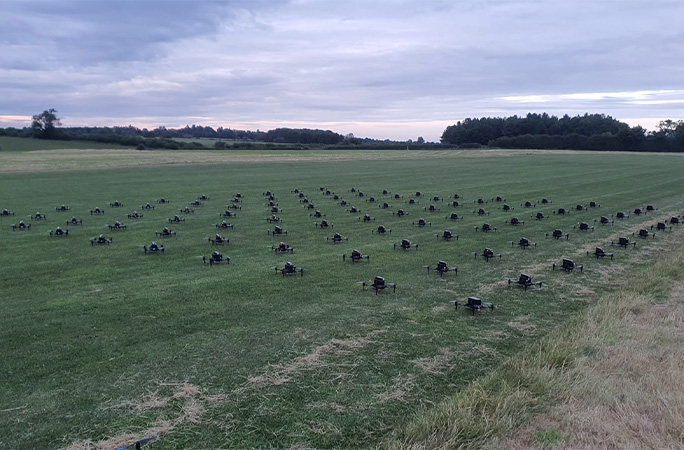 Drones lined up on the ground before take off