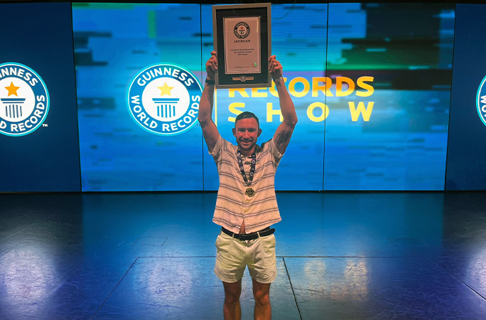MSC passenger holds up a certificate