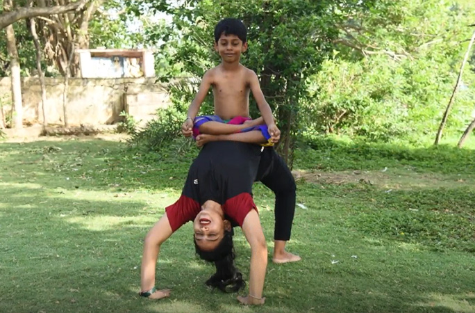 Pratyaksh sat with his legs crossed on top of his mum