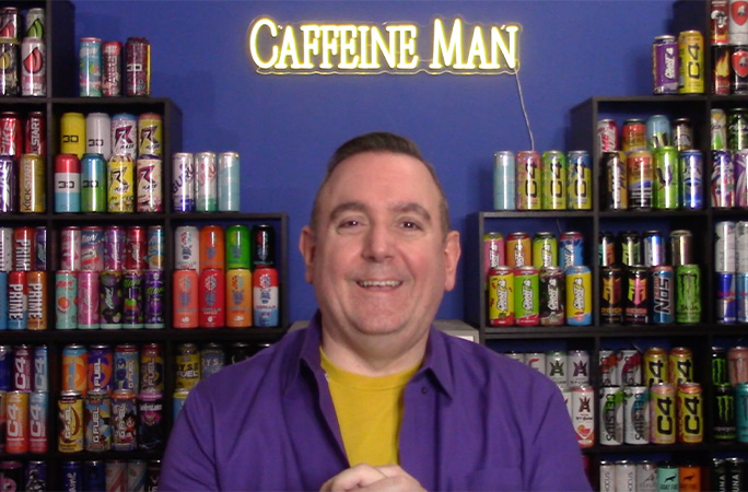 Joel smiling as he poses in front of his collection